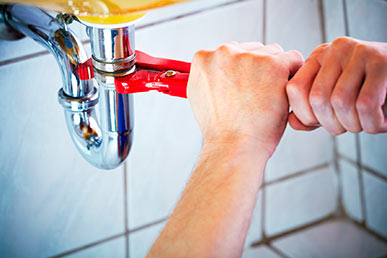 one of our plumbers is fixing a kitchen drain