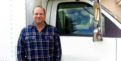 Mike is standing ready by his plumbing truck